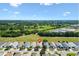 An aerial view of neighborhood with tree lined streets and an adjacent golf course at 1615 Navidad St, The Villages, FL 32162