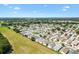 Wide aerial view highlighting the layout of the neighborhood with mature landscaping at 1615 Navidad St, The Villages, FL 32162