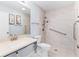 Bright bathroom featuring a walk-in shower with grab bars and neutral tile at 1615 Navidad St, The Villages, FL 32162
