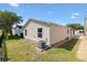 Home exterior with sliding glass doors and air conditioning unit at 1615 Navidad St, The Villages, FL 32162