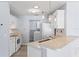 Bright kitchen with modern appliances and adjacent laundry area provides convenience at 1615 Navidad St, The Villages, FL 32162