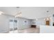 Open-concept space with hardwood floors, recessed lighting, and a sliding glass door at 1615 Navidad St, The Villages, FL 32162