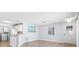 Well-lit living space with hardwood floors, modern light fixtures, and a view of the kitchen at 1615 Navidad St, The Villages, FL 32162
