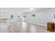 Open living area featuring hardwood floors, natural light, and kitchen views at 1615 Navidad St, The Villages, FL 32162