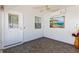Inviting screened porch featuring neutral color walls, decorative art, and ceiling fan at 1615 Navidad St, The Villages, FL 32162