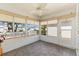 Enclosed porch with multiple windows for natural light and neutral flooring at 1615 Navidad St, The Villages, FL 32162