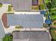 A home aerial view with a patio, meticulous landscaping and outdoor umbrella shade at 1713 Jadestone Ter, The Villages, FL 32162
