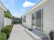 Exterior side view of a home with a patio, yard and grill at 1713 Jadestone Ter, The Villages, FL 32162