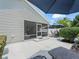 Exterior of home showing screened patio and open patio for relaxing and entertaining at 1713 Jadestone Ter, The Villages, FL 32162