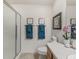 Bathroom featuring a glass shower, framed artwork, and decorative towels at 1713 Jadestone Ter, The Villages, FL 32162