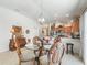 Cozy dining room featuring a round table, decorative chairs, and open access to the kitchen at 1713 Jadestone Ter, The Villages, FL 32162