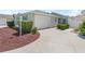 A well-maintained home with a charming exterior, featuring a manicured lawn and a convenient attached garage at 1713 Jadestone Ter, The Villages, FL 32162