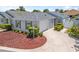 Charming home featuring an attached garage, landscaped front yard, and a circular driveway at 1713 Jadestone Ter, The Villages, FL 32162