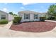 A charming single-story home showcasing a well-manicured front yard with vibrant, low-maintenance landscaping at 1713 Jadestone Ter, The Villages, FL 32162