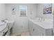 Bright laundry room with washer, dryer, sink, and a window allowing natural light at 1713 Jadestone Ter, The Villages, FL 32162