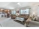 Comfortable living room with a view of the dining area, perfect for relaxation and gatherings at 1713 Jadestone Ter, The Villages, FL 32162