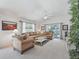 Inviting living room with comfortable sofas, natural light, and access to the outdoor area at 1713 Jadestone Ter, The Villages, FL 32162