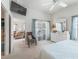 Bright main bedroom showcases a dresser and a glimpse into the adjoining living room at 1713 Jadestone Ter, The Villages, FL 32162