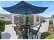 Outdoor patio with seating under a large umbrella at 1713 Jadestone Ter, The Villages, FL 32162