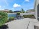 Charming outdoor patio featuring a dining set and lush landscaping at 1713 Jadestone Ter, The Villages, FL 32162