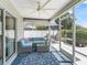 Inviting screened patio with comfortable seating and ceiling fan, perfect for relaxation at 1713 Jadestone Ter, The Villages, FL 32162