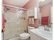 Bathroom featuring a tiled shower with glass doors, vanity, and white fixtures at 1728 Morelos Rd, The Villages, FL 32159