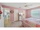 Bright bedroom with ceiling fan, TV, ensuite bathroom, and a cozy bed at 1728 Morelos Rd, The Villages, FL 32159