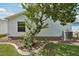 Exterior view of the home with neatly maintained landscaping and an efficient air conditioning unit at 1728 Morelos Rd, The Villages, FL 32159