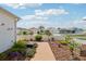 Charming front yard featuring well-manicured landscaping, vibrant flowers, and a welcoming walkway to the home at 1728 Morelos Rd, The Villages, FL 32159