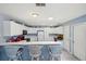 Kitchen bar area featuring modern appliances, ample counter space, and stylish bar stools at 1728 Morelos Rd, The Villages, FL 32159