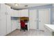 Efficient kitchen design includes desk area and extra storage cabinets at 1728 Morelos Rd, The Villages, FL 32159