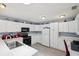 Bright kitchen features white cabinets, modern appliances, and ample countertop space at 1728 Morelos Rd, The Villages, FL 32159