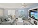 Cozy living room featuring a plush sofa, entertainment center, and elegant decor at 1728 Morelos Rd, The Villages, FL 32159