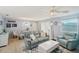 Bright living room with a plush sofa, a large white coffee table, and elegant floor lamps at 1728 Morelos Rd, The Villages, FL 32159