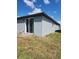 Backyard view with sliding glass doors and freshly installed stucco at 1808 Carnostie Rd, Winter Haven, FL 33884