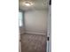 A cozy bedroom features neutral carpet, fresh paint, and a bright window at 1808 Carnostie Rd, Winter Haven, FL 33884