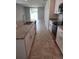 Bright, open kitchen with granite countertops, stainless appliances, and tile flooring at 1808 Carnostie Rd, Winter Haven, FL 33884