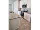 A modern kitchen with granite countertops, stainless steel appliances, and white cabinets at 1808 Carnostie Rd, Winter Haven, FL 33884