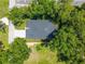 An aerial view showcases the property's rooftop and surrounding lush greenery, offering a secluded and serene atmosphere at 201 Hillside Ave, Umatilla, FL 32784