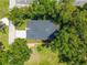 A top-down aerial view of the property, showcasing the roof, driveway, and surrounding trees at 201 Hillside Ave, Umatilla, FL 32784