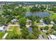 Aerial view of a property with lush surroundings and a serene lake nearby at 201 Hillside Ave, Umatilla, FL 32784