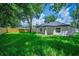 Expansive backyard showcasing lush lawn, privacy fence, and covered patio for outdoor enjoyment at 201 Hillside Ave, Umatilla, FL 32784