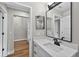 Bathroom sink with marble countertop, black faucet, and view to shower at 201 Hillside Ave, Umatilla, FL 32784