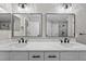 Modern bathroom featuring double sinks, sleek countertops, and decorative lighting fixtures at 201 Hillside Ave, Umatilla, FL 32784