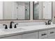 Bathroom with double sinks, modern fixtures, and white shaker cabinets at 201 Hillside Ave, Umatilla, FL 32784
