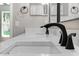 Close-up of the double sink bathroom vanity with black faucets at 201 Hillside Ave, Umatilla, FL 32784
