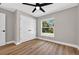 Cozy bedroom with wood-look floors, large window offering a green view, and closet at 201 Hillside Ave, Umatilla, FL 32784