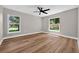 Bedroom with wood-look floors, white trim and neutral paint at 201 Hillside Ave, Umatilla, FL 32784