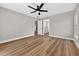 Bedroom with wood-look floors and a view of the adjoining bathroom at 201 Hillside Ave, Umatilla, FL 32784