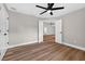 This bedroom includes a ceiling fan and a view into another room through double doors at 201 Hillside Ave, Umatilla, FL 32784